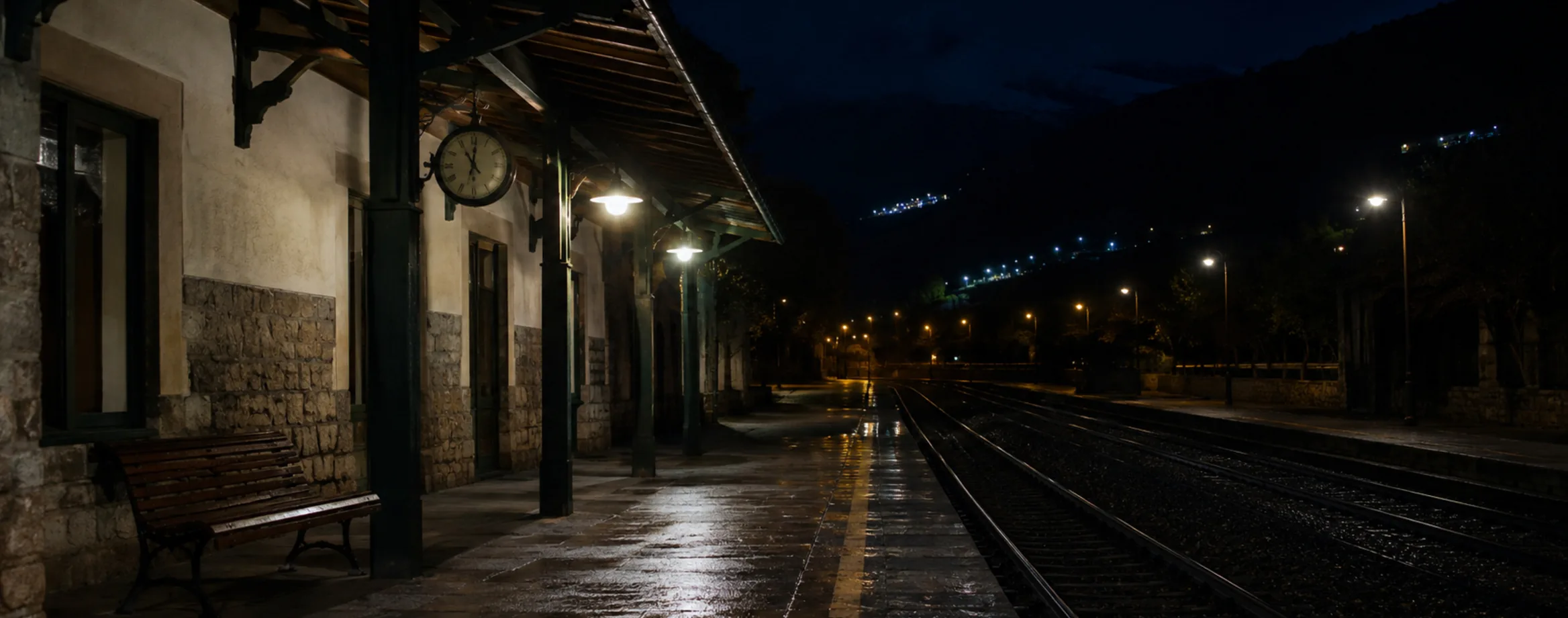 An empty station platform at night