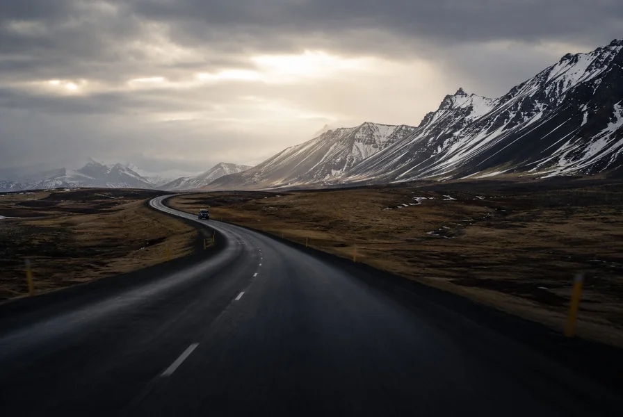 An empty road and oncoming headlights on Route 1, Iceland