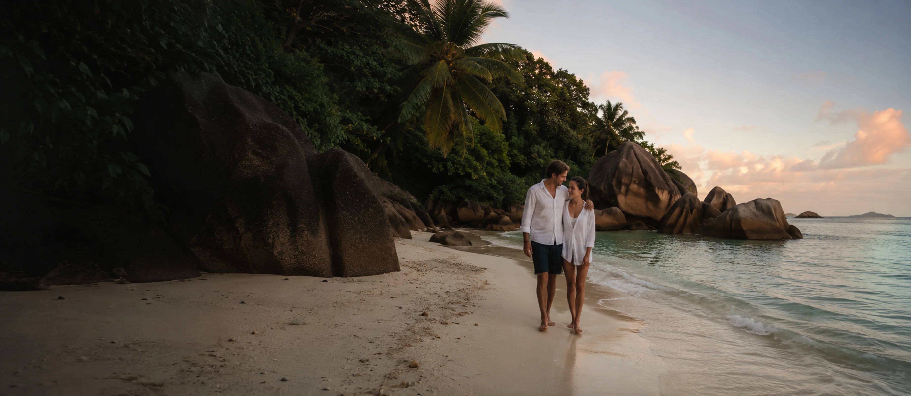 Two travellers alone in early light with nobody else in the frame, Seychelles