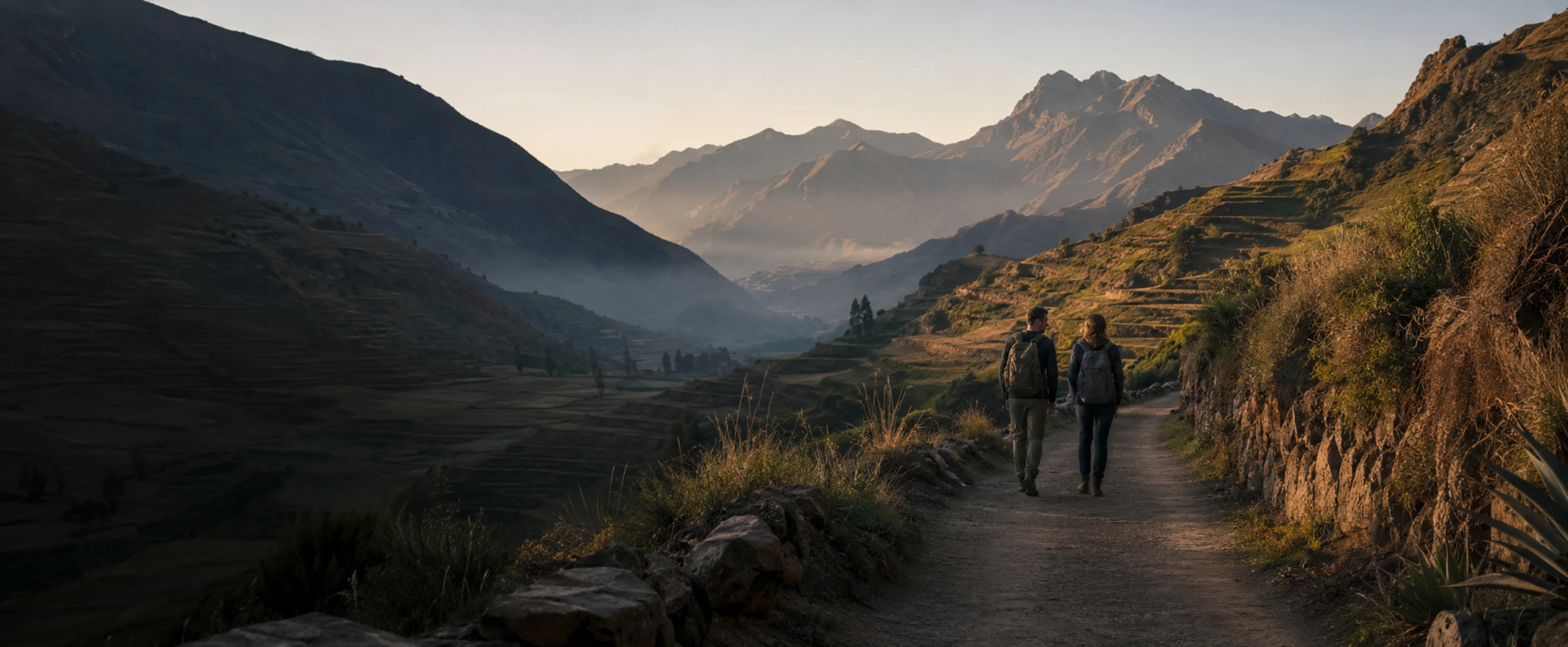 Two travellers alone on a wide route in the Sacred Valley, small in a big landscape